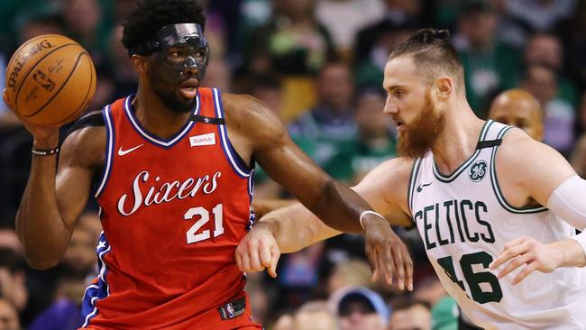 Australia’s Aron Baynes shuts down a masked Joel Embiid last week