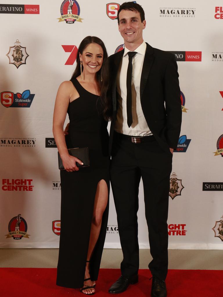 Chelsea Gillam wearing Nooki, and Jake Summerton pose for a picture on the red carpet at Adelaide Oval in North Adelaide, for the Magarey Medal, Monday, September 9, 2019. Picture: Matt Loxton