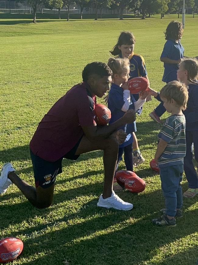 Keidean Coleman of the Brisbane Lions with kids at the Auskick Murri Carnival program in Toowoomba.