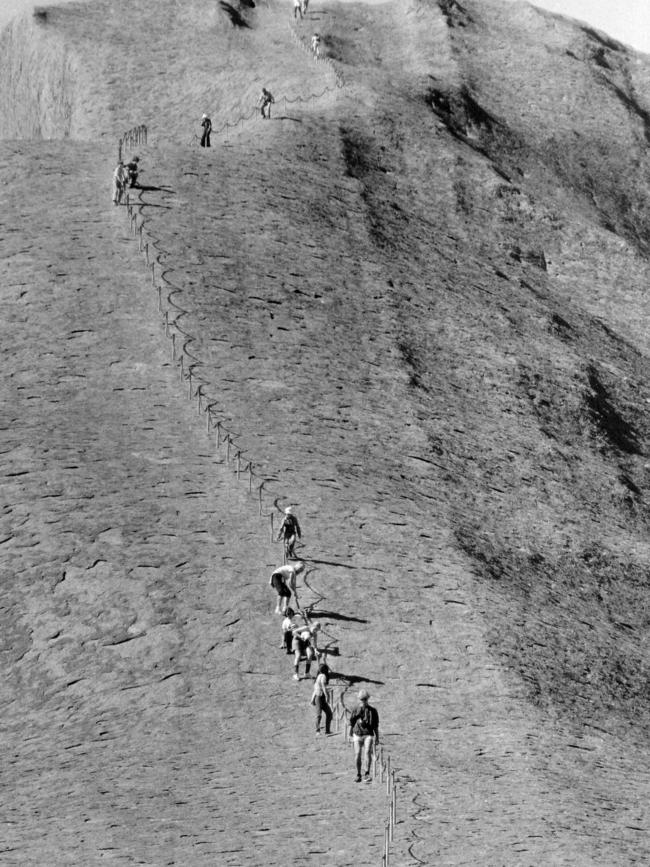 Visitors to Uluru during the arduous climb up the giant monolith. Pic. Archive News Ltd Published: Northern Territory News - September 18, 1987