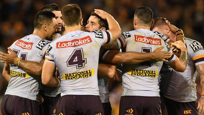 Broncos players celebrate their golden point win on Friday night.