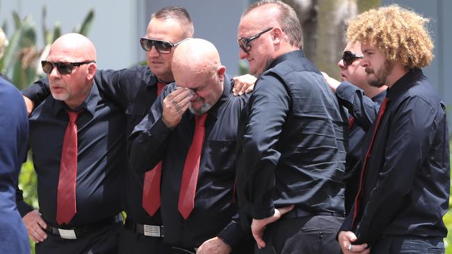 Les Ross (middle) comforted by friends at son Shane Ross’ funeral held at Southport Church of Christ.
