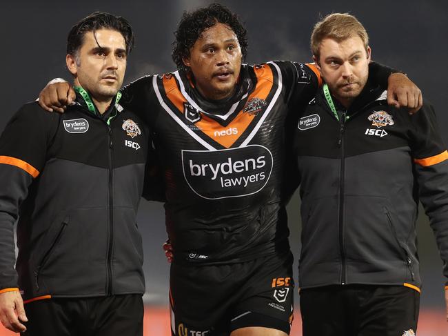 Luciano Leilua is helped from the field late in round five. Picture: AAP Image/Brendon Thorne