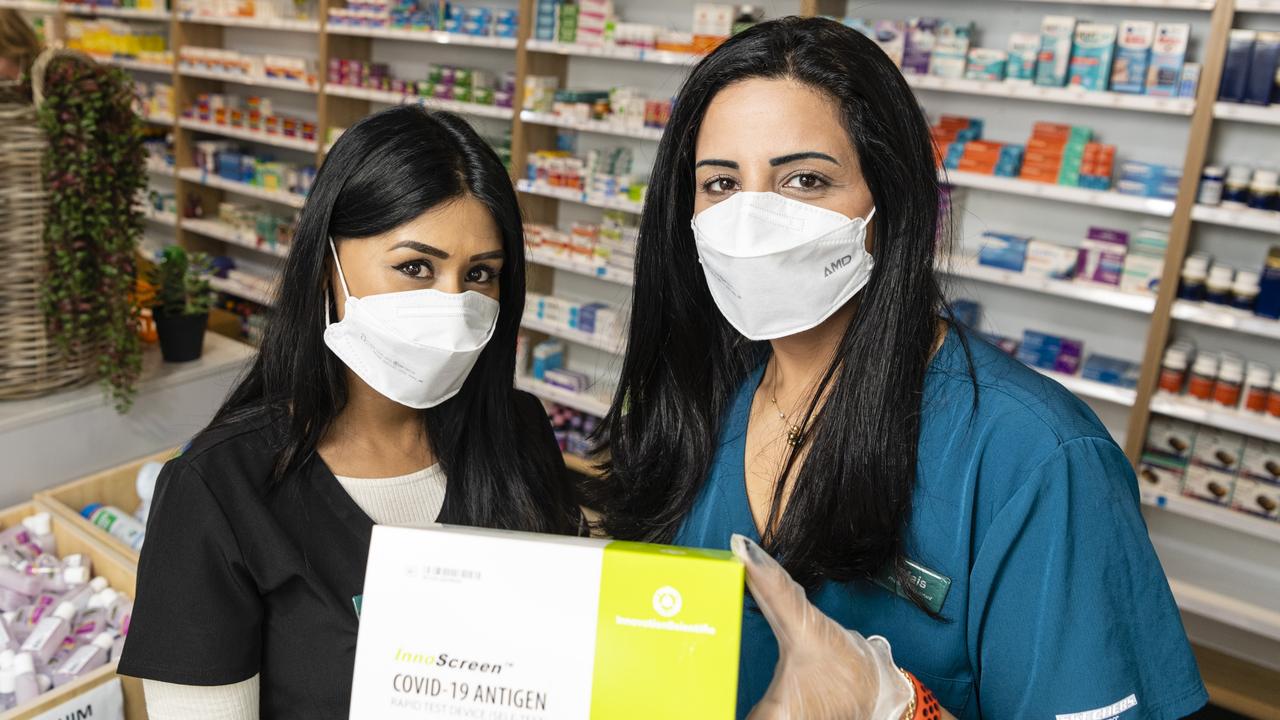 Toowoomba Day and Night Pharmacy pharmacist Monica Kailey (left) and pharmacy assistant Mais Karam with a pack of 20 Covid RATs that cannot be sold separately, Monday, January 24, 2022. Picture: Kevin Farmer