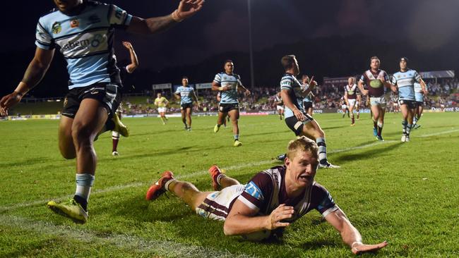 Tom Trbojevic (centre) of the Sea Eagles scores a try that was later disallowed during the round 3 NRL match between the Manly Sea Eagles and the Cronulla Sutherland Sharks at Brookvale Oval in Sydney on Monday, March 21, 2016. (AAP Image/Paul Miller) NO ARCHIVING, EDITORIAL USE ONLY