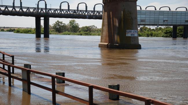 The flooded wharf at Sturt Reserve and the 1956 flood marker at Murray Bridge. Picture: Dylan Hogarth