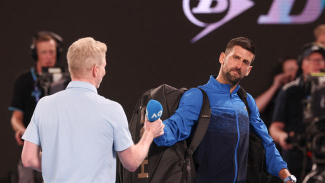 Serbia's Novak Djokovic (R) gives back the microphone after speaking on court after winning his men's singles match against Czech Republic's Jiri Lehecka on day eight of the Australian Open tennis tournament in Melbourne on January 19, 2025. (Photo by DAVID GRAY / AFP) / -- IMAGE RESTRICTED TO EDITORIAL USE - STRICTLY NO COMMERCIAL USE --