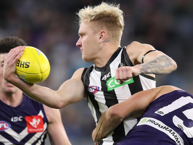 PERTH, AUSTRALIA - AUGUST 02: Jaidyn Stephenson of the Magpies is tackled by Ethan Hughes of the Dockers during the round nine AFL match between the Fremantle Dockers and the Collingwood Magpies at Optus Stadium on August 02, 2020 in Perth, Australia. (Photo by Will Russell/AFL Photos/via Getty Images)