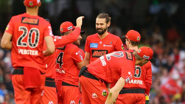 Kane Richardson is mobbed by teammates after taking a wicket at Marvel Stadium.