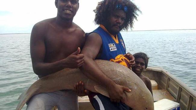 L-R: Aaron Daniels, Frances Vigona-Daniels, Gilly B with a baby dugong that Mr Vigona-Daniels says was released back into the water on a hunting trip in Territory waters.