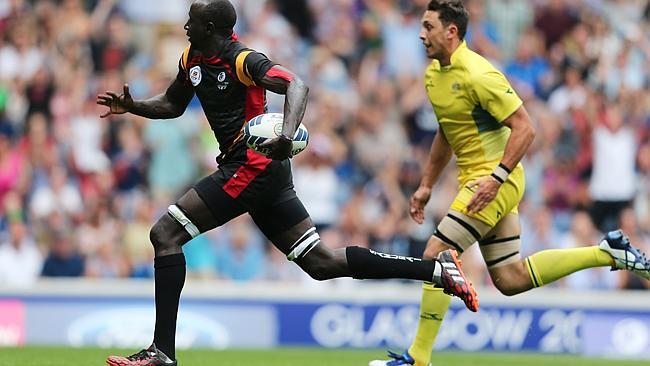 Emma Ecodu of Uganda outpaces Con Foley of Australia to score a try.