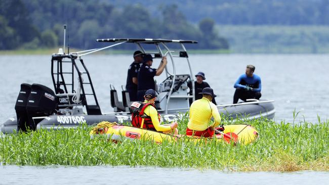 Police divers and Queensland Fire and Emergency Services personnel search the waters off the Lake Tinaroo boat ramp for the body of a 49 year old Atherton man, who was swimming in the lake around 11am Sunday and failed to resurface. Photo: Brendan Radke