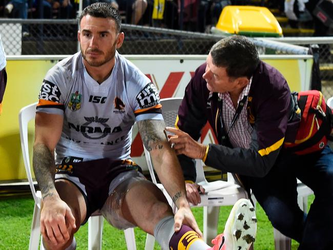 Darius Boyd of the Broncos sits on the bench with ice strapped to his left leg.