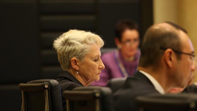 Phelps (left) and Moore (background centre) have often been at odds in council meetings