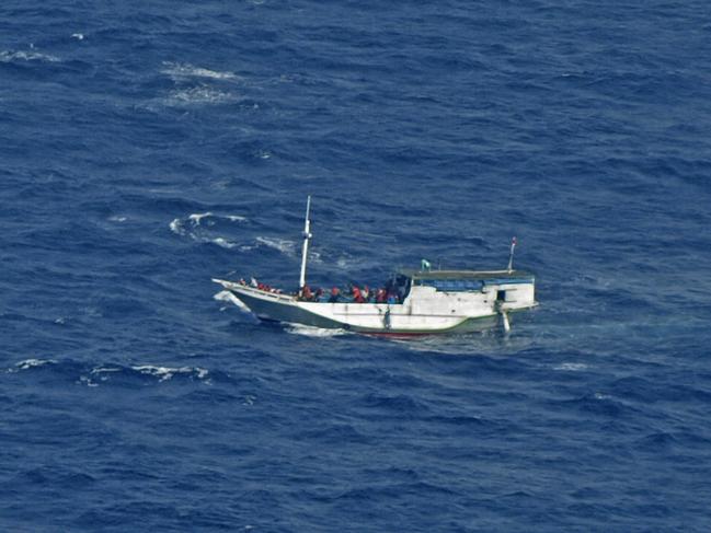 FILE - In this July 4, 2012 file photo released by the Indonesian National Search and Rescue Agency, a wooden boat which is believed to have up to 180 asylum seekers on board floats on the waters off Christmas Island, Australia. Australian officials said Saturday, July 13, 2013, a boat carrying asylum seekers from Indonesia to Australia began sinking Saturday in the Indian Ocean. Australian officials rescued 88 asylum seekers on Friday night after the boat began taking on water about 200 kilometers (120 miles) north of Christmas Island, an Australian territory 500 kilometers (310 miles) south of Jakarta, Indonesia. (AP Photo/Indonesian National Search and Rescue Agency, File)