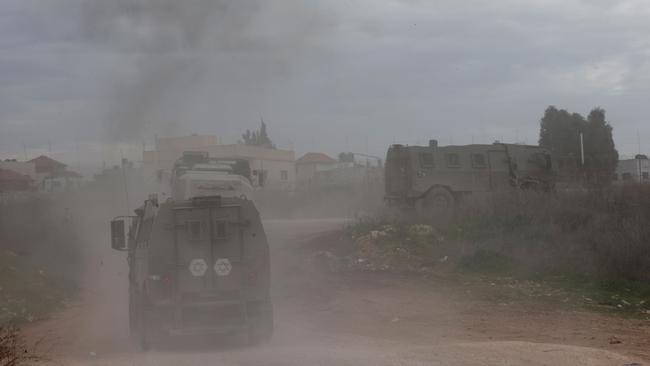 Israeli military vehicles in the occupied West Bank as gunfire and explosions rocked the Jenin area in a large-scale raid for a second day. Picture: AFP