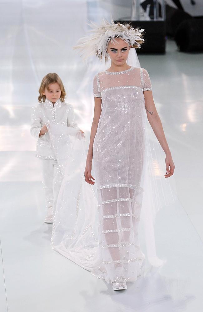 Runaway bride British "It" girl Cara Delevingne in the show-stopper with Karl Lagerfeld's godson Hudson Kroening cast as page boy in a mock wedding. Picture: AFP