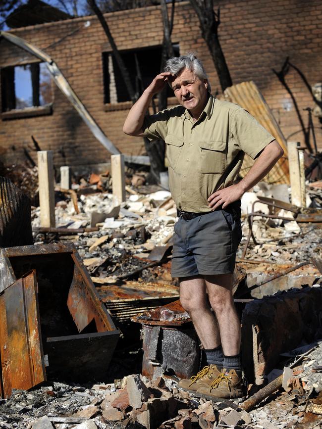 David Barton among the ruins of the Marysville fire in 2009.