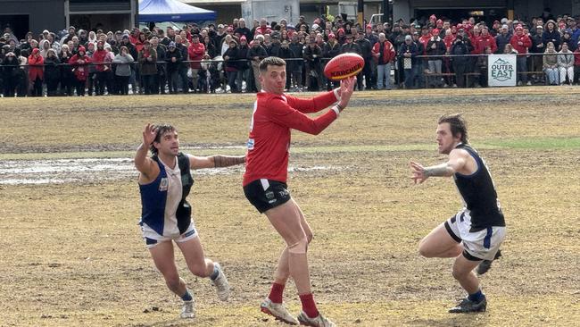 Patrick Murray gets a handball away.