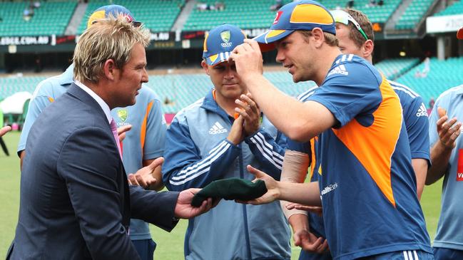 Michael Beer receives his baggy green cap from Shane Warne ahead of his Test debut in 2011.