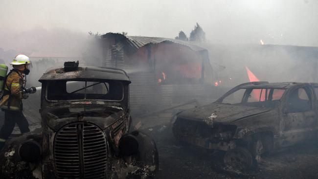 Rural Fire Service firefighters extinguish a fire on a property on January 23, 2020 in Moruya. Picture: Sam Mooy/Getty