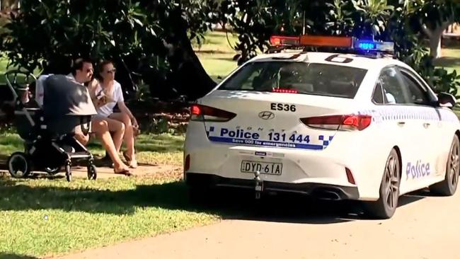 NSW police drive through the park in Rushcutters Bay to move-on people assembling in groups as part of the state's bid to enforce social distancing measures. Pic: Sky News