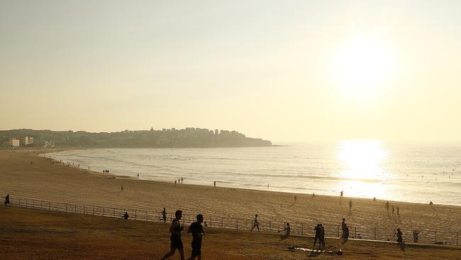 Smoke covers Bondi Beach at sunrise today. Picture: Getty