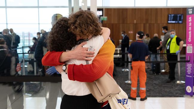 People reuniting at Adelaide Airport on the first day of the border opening. Picture: NCA NewsWire / David Mariuz