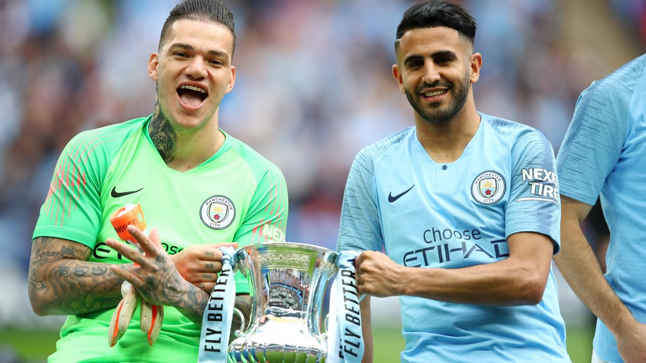Ederson and Riyad Mahrez of Manchester City celebrate with the trophy following the FA Cup Final.