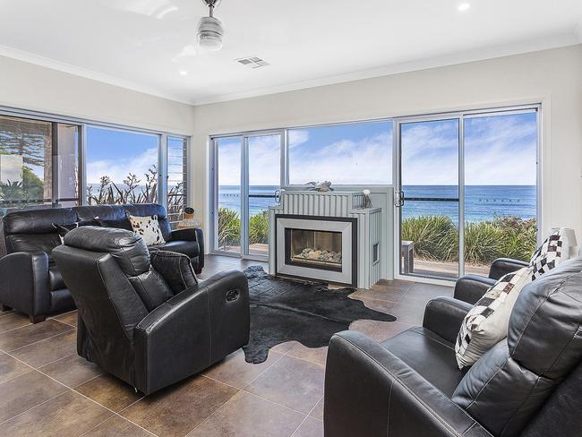 The fireplace is surrounded an ocean backdrop.