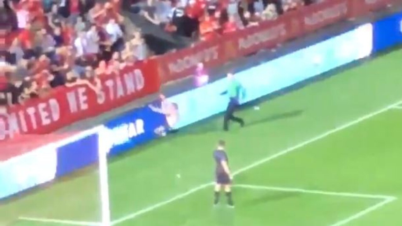 The streaker crashes into the advertising boards.