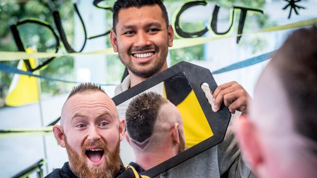 Dustin Martin's barber Sakkarin Onnom gives Chris McMullan a Dusty-style haircut ahead of a charity event being held at True Barbers Elwood. Picture: Jake Nowakowski