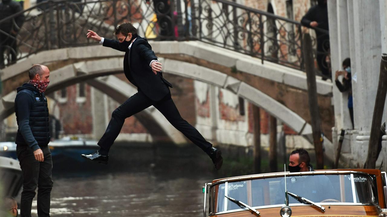 Tom Cruise (C) jumps between two taxiboats during the shooting of the film Mission Impossible: Lybra in Venice. Picture: MARCO SABADIN / AFP