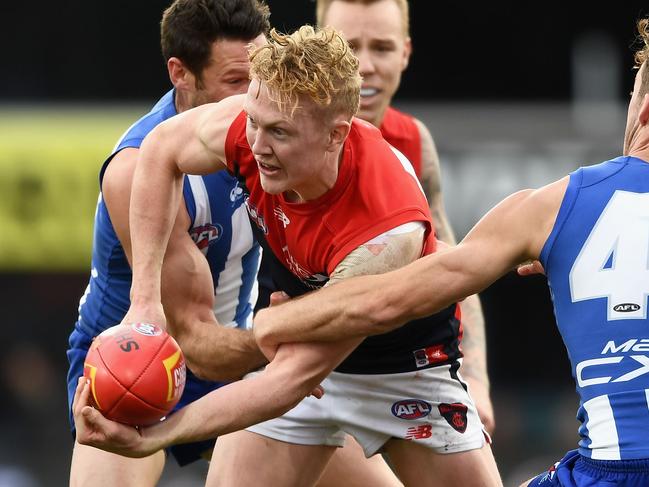 HOBART, AUSTRALIA - JULY 29:  Clayton Oliver of the Demons handballs whilst being tackled by Declan Mountford of the Kangaroos  during the round 19 AFL match between the North Melbourne Kangaroos and the Melbourne Demons at Blundstone Arena on July 29, 2017 in Hobart, Australia.  (Photo by Quinn Rooney/Getty Images)