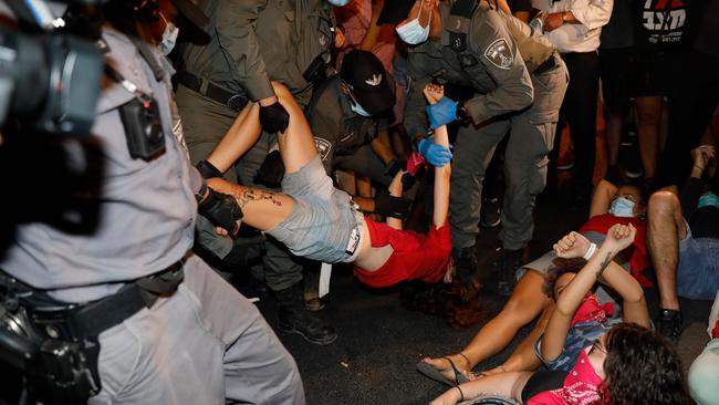 Police remove protesters blocking a main road during a demonstration against the Israeli government near the Prime Minister’s residence in Jerusalem. Picture: AFP