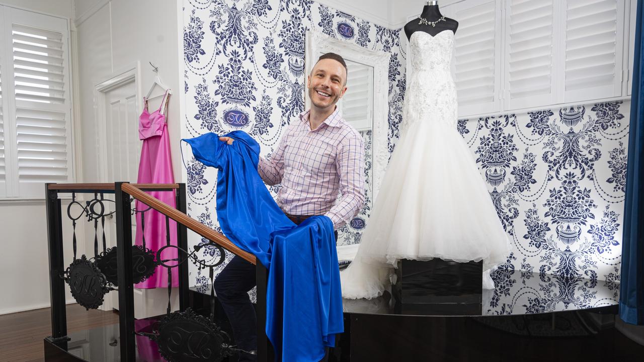 David Walker of Brandaquarium in the Touch of Romance Bridal and Formal showroom in Highfields with a showpiece Roz la Klein bridal gown on display in the background, Thursday, March 28, 2024. Picture: Kevin Farmer