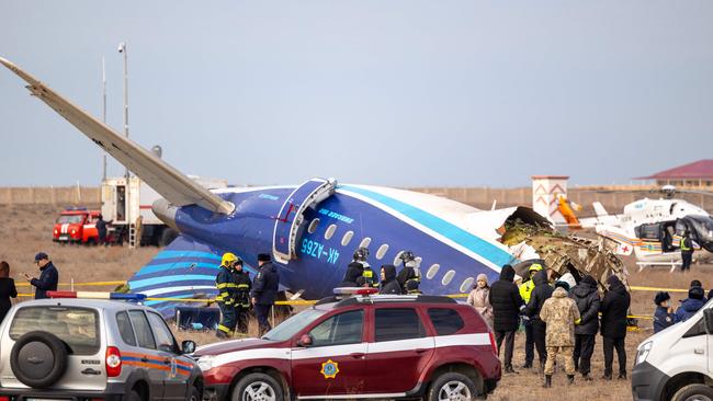 Emergency specialists work at the crash site of an Azerbaijan Airlines passenger jet near the western Kazakh city of Aktau on December 25, 2024. (Photo by Issa Tazhenbayev / AFP)