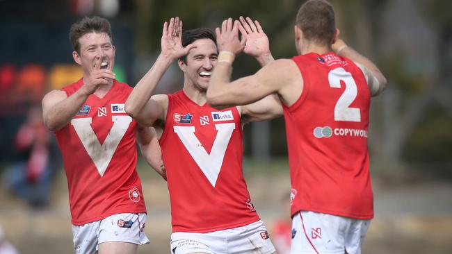 Andrew Moore (No.2) celebrates with North Adelaide teammates Campbell Combe (left) and Tom Schwarz against Norwood at Prospect Oval on Saturday. Picture: DEAN MARTIN.