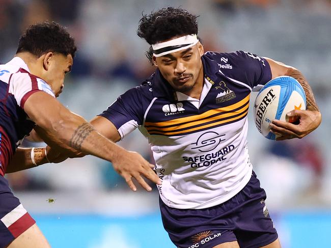David Feliuai tries to beat the Reds defence. Picture: Getty Images