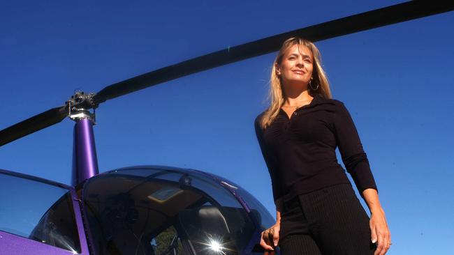 AUGUST 26, 2003 : Author Allana Corbin who is a pilot with her own helicopter in background at Hobart Airport, 26/08/03. Pic Chris Crerar. F/L Tasmania / Aviation / Aircraft