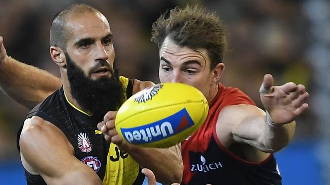 Bachar Houli of the Tigers (left) and Tim Smith of the Demons contest during the Round 6 AFL match between the Richmond Tigers and the Melbourne Demons at the MCG in Melbourne, Wednesday, April 24, 2019. (AAP Image/Julian Smith) NO ARCHIVING, EDITORIAL USE ONLY