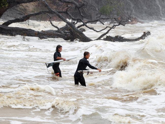 Surfers head out into large waves and rough seas from Cyclone Gabrielle at Goat Island Marine Reserve in Auckland, New Zealand. Picture: Getty Images