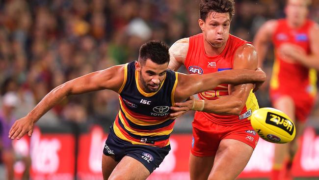 Wayne Milera of the Crows competes against Jesse Lonergan of the Suns.