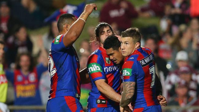 Peter Mata'utia celebrates a try with Knights teammates.