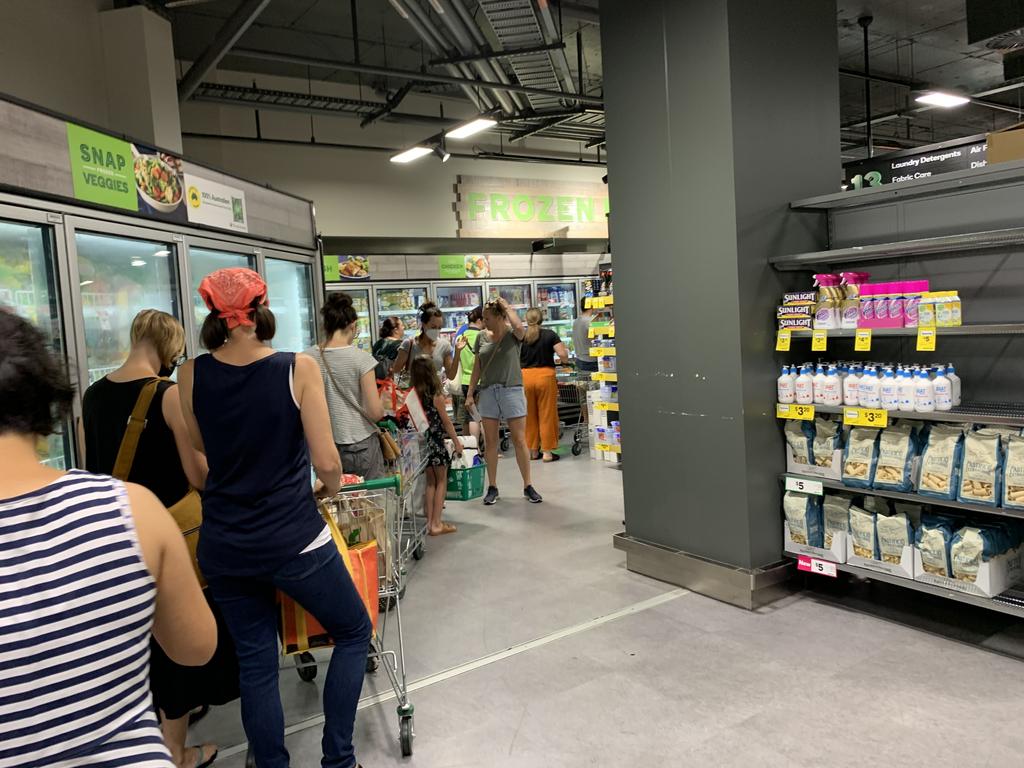 At one Woolworths store, the queue for a checkout wrapped around the store. Picture: NCA NewsWire