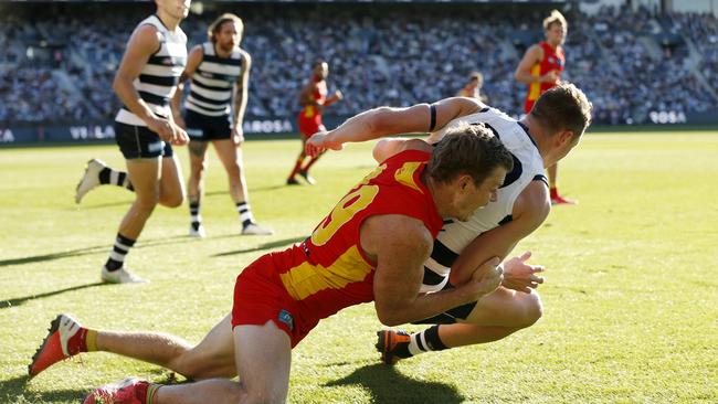 Nick Holman tackles Mitch Duncan into the turf on Saturday afternoon. Picture: Darrian Traynor/AFL Photos