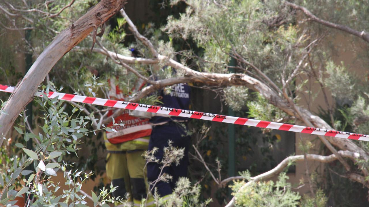 Northern Territory Firefighters liaise with fire investigators. Picture: Gera Kazakov