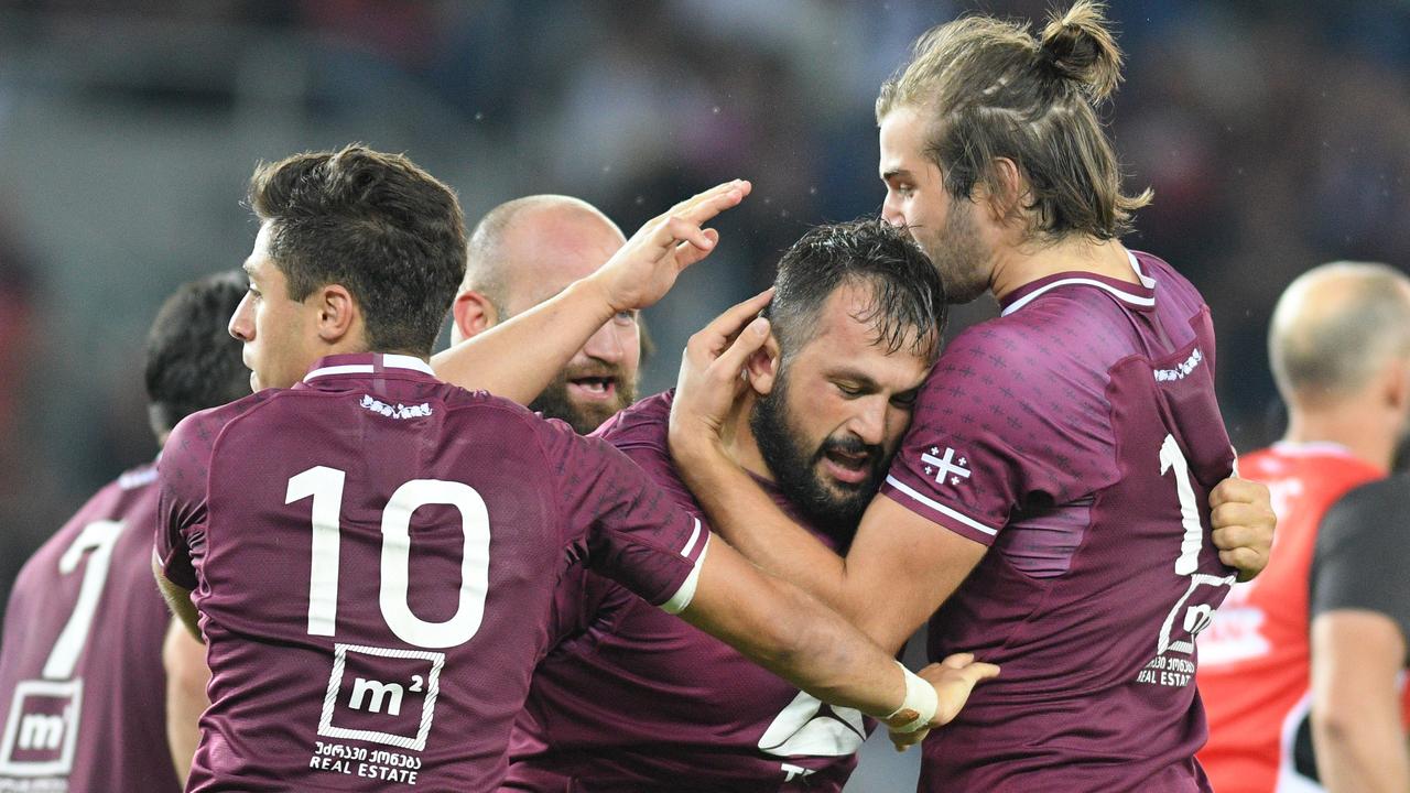 Tedo Abzhandadze, Karlen Asieshvili and Mirian Modebadze of Georgia celebrate.