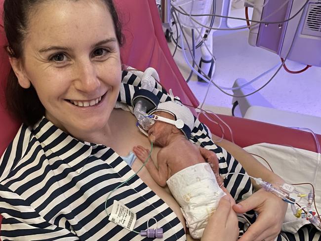 Sarah Kirby holds her son Teddy who weighed just 719 grams at birth at The Women’s and could almost fit in the palm of her hand.