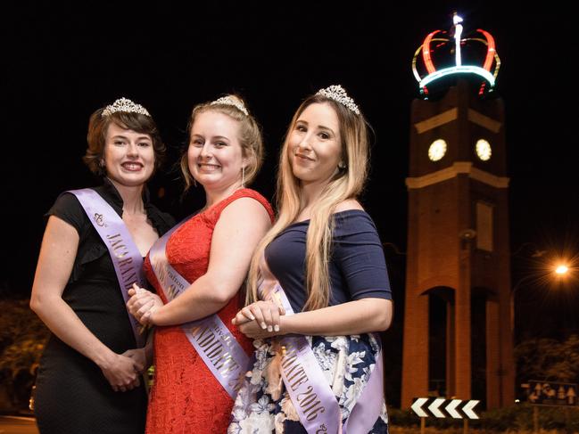 2016 Jacaranda candidates Sharni Wren, Heidi Madsen and Shannon Carter in front of the lit up Jacaranda Crown that was placed on top of the clocktower in preparation for the festival.